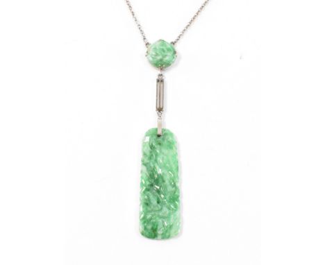 A 1920s Art Deco 9ct white gold and jade pendant necklace. The necklace having a fine link chain with two carved jade panels 