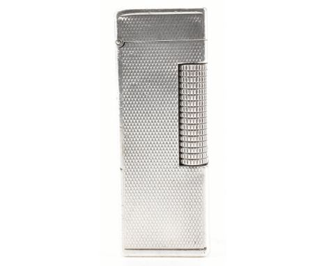 A mid 20th century 1960s hallmarked silver Dunhill lighter. The lighter coming with a hobnail decoration. Serial N. BRIT72698