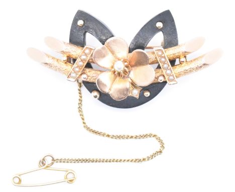 A 19th Century Victorian rose gold and jet brooch. The antique brooch having a central applied shamrock with on two curved ba