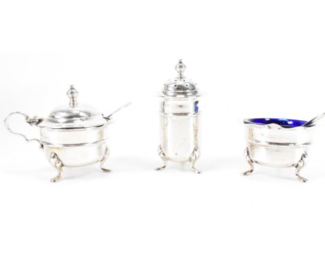 An Adie Brothers silver hallmarked cruet set. The set including a lidded mustard pot, table salt and pepper pot. Hallmarked B