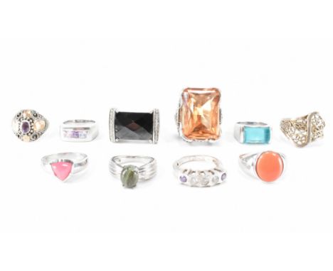 A group of ten silver stone set rings. The lot to include a faceted black stone ring, orange stone dress ring, filigree ring 