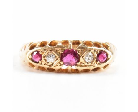 A early 20th Century 18ct gold ruby and diamond five stone ring. The ring being set with three round cut rubies and two round