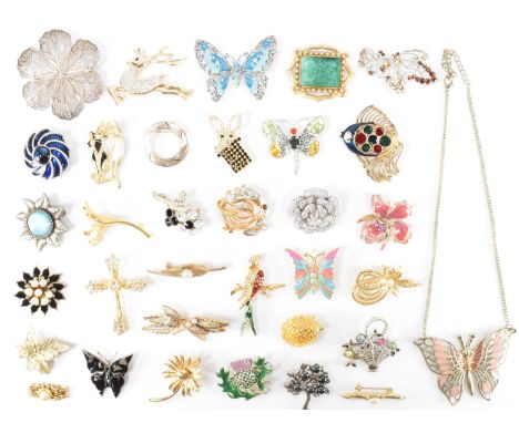 An assortment of vintage brooches to include an enamelled orchid example, a 1970's faux jade frame brooch, a silver cannetill