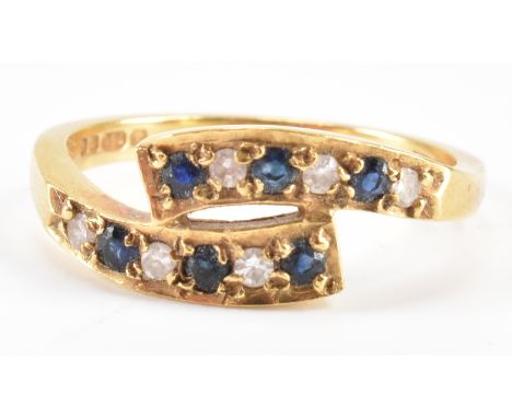 A hallmarked 18ct gold sapphire and diamond crossover band ring. The ring set with sapphires and single cut diamonds. Weight 