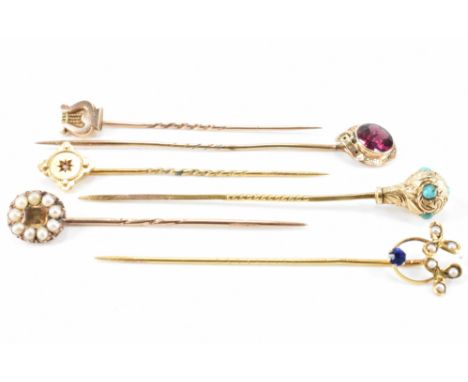 A group of six 19th Century antique stick pins. The lot to include an amethyst buckle pin, a turquoise set pin, a topaz and s