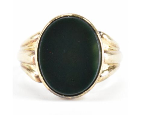 A vintage gold and blood stone signet ring. The ring having an oval bloodstone panel to the head with reeded shoulders. Shank