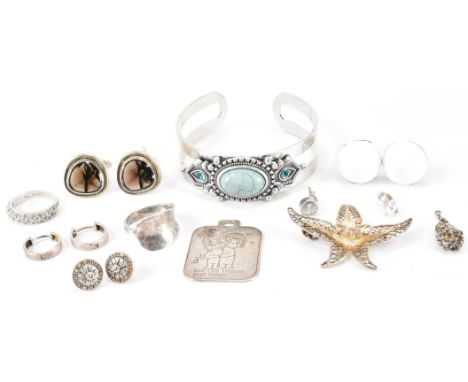 An assortment of silver jewellery to include a Suarti style Indian style bangle bracelet set with a turquoise cabochon, a sil
