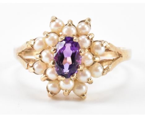 A hallmarked 9ct gold, amethyst and seed pearl cluster ring. The ring having an oval cut amethyst to the head with a halo of 