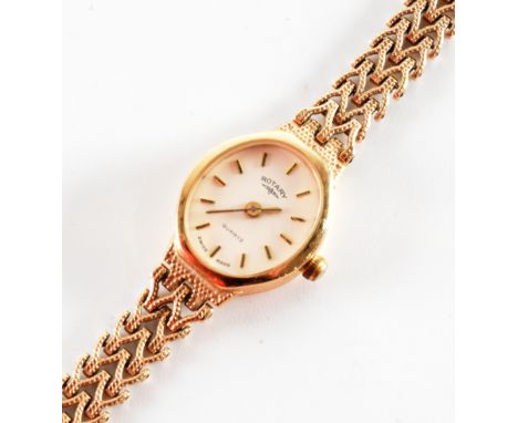 A hallmarked 9ct gold Rotary quartz cocktail watch. The watch having a white oval face with baton markers to the chapter ring