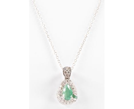 A diamond and emerald pendant necklace. The pendant having a pear cut emerald to the centre with three&nbsp; further round cu