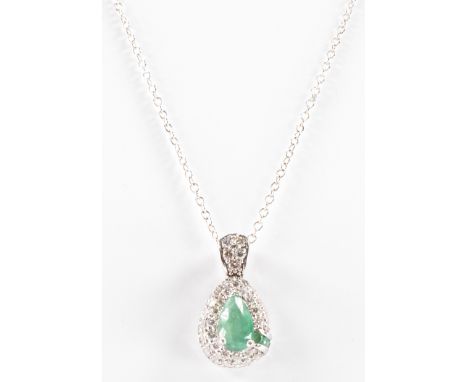 A diamond and emerald pendant necklace. The pendant having a pear cut emerald to the centre with three&nbsp; further round cu