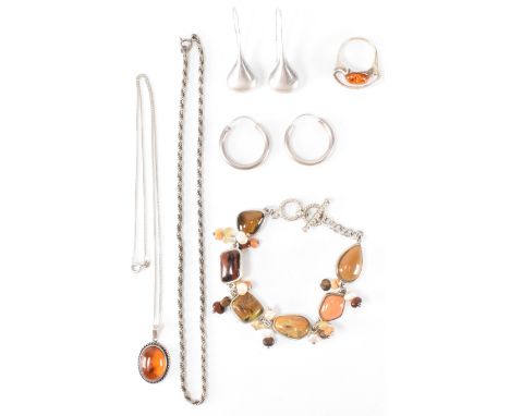 A collection of silver and amber jewellery to include an amber cabochon pendant on chain necklace, a modernist style silver d