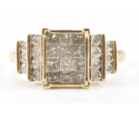 A hallmarked 9ct gold and diamond cluster ring. The ring having a rectangular head set with twelve square cut diamonds to the