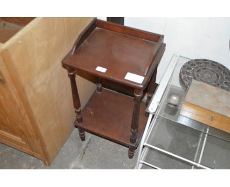 A mahogany two tier shelf unit