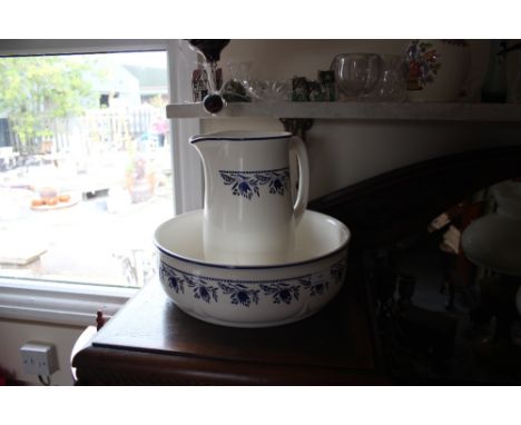 A blue and white china toilet jug and basin, a floral hand basin and a floral chamberpot