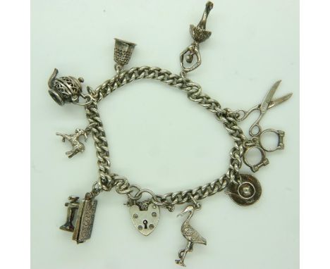 Hallmarked silver charm bracelet with nine charms, 39g. UK P&amp;P Group 0 (£6+VAT for the first lot and £1+VAT for subsequen