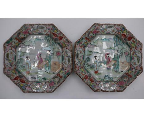 A pair of Japanese 19th century octagonal plates, the border decorated with panels of butterflies and exotic birds, the centr