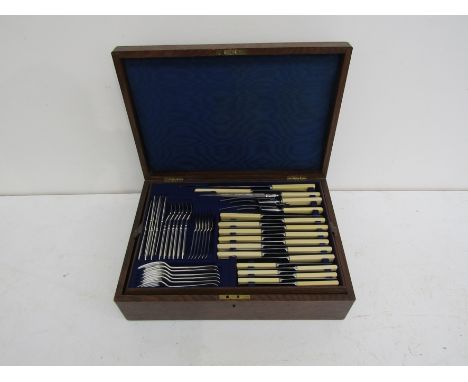 A canteen containing a matched Wm Hutton &amp; Sons Ltd set of cutlery, a Turner &amp; Co. ivory handled carving set with kni