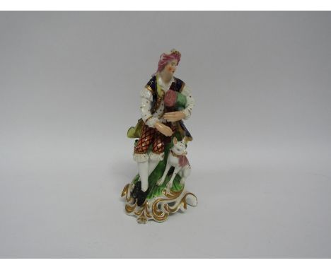 A Derby porcelain "Pipe" shepherd figure, seated with dog at foot, surrounded by flowering bocage on rococo scroll base. Mode