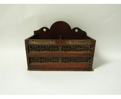 An Edwardian oak wall letter sorting box, the shaped back above two divisions , lettered brass titles on the front "Post" and