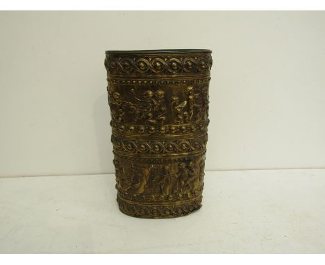 A large oval 19th century repousse brass stick/umbrella stand, with a separate tin liner, featuring marching groups of sporti