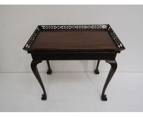 A George II style mahogany silver table with a canted pierced fretwork gallery and blind fretwork frieze over cabriole legs o