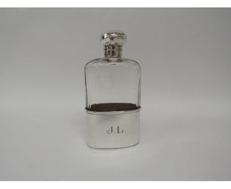 A 19th century silver mounted cut glass spirit flask with chamfered shoulders, fluted sides with silver dimpled bayonet cap a