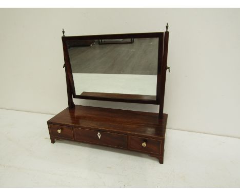 An early 19th century mahogany and crossbanded toilet miror, the landscape plate between reeded uprights with urn finials ove