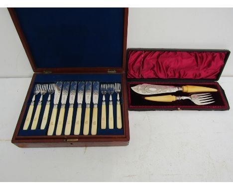 Eighteeen pairs of Victorian silver plated fish knives and forks, the blades engraved with a geometric design, the handles wi