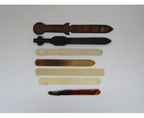 A group of page turners and letter openers including one with a folding quill cutter, a carved crocodile, a St Patrick celtic