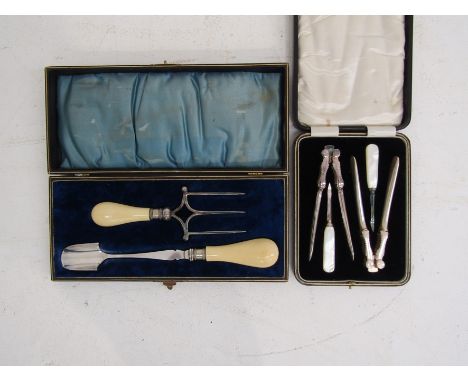 A stilton cheese scoop and matching bread fork presented in a fitted case together with a fitted case containing a matching p