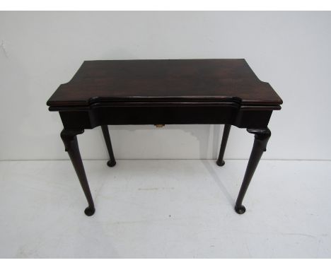 A George II mahogany card table Circa 1740-50, the breakfront hinged and foldover top on a double-gate support, revealing a b