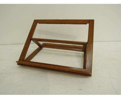 A mid-century beech book stand based on the British Library model. 52cm wide
