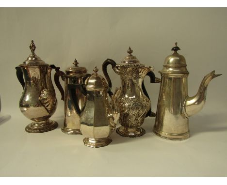 An 18thC Old Sheffield Plated coffee pot, the domed hinged lid with a gadrooned edge and flame finial, a double scroll carved