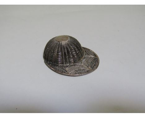 A George III silver filigree caddy spoon in the form of a jockey's cap with basket weave decoration and filigree brim. Circa 