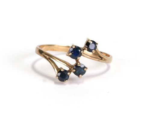 A 9ct gold and sapphire four-stone cross-over ring, approx UK size 'O'.