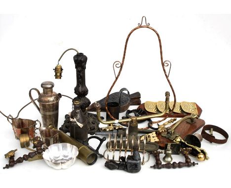 A quantity of metalware to include a spelter lamp base; together with a brass door knocker; a shop door bell and other items.