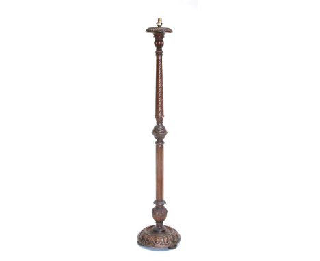 An Edwardian carved oak standard lamp, 148cms (58ins) high. (a/f)Condition ReportIt has been broken and re-glued and has some