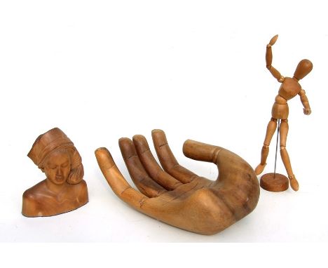 A treen carved fruit bowl in the form of a hand, 35cms (14ins) diameter; together with an artist's articulated figure; and a 