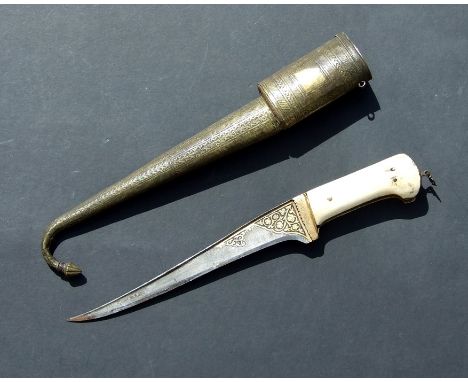 A Persian bone handled dagger with gilded decoration steel blade, in an ornate brass scabbard, overall 45.75cms (18ins) long.