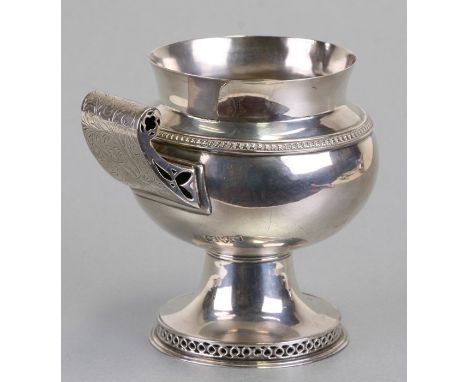 An Arts &amp; Crafts silver footed jug with pierced scroll handle and foot rim with pierced decoration, George Nathan &amp; R