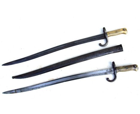 An 1868 pattern French Chassepot bayonet and scabbard; together with another similar without scabbard (2).