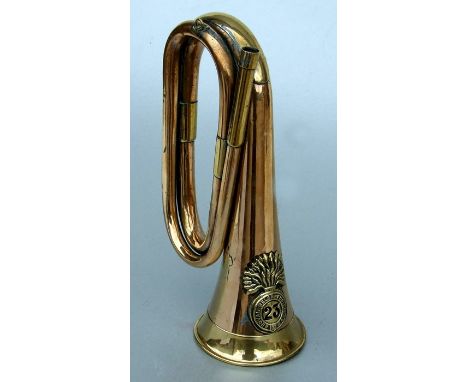 A Royal Welsh Fusiliers copper &amp; brass bugle (lacks mouthpiece), 28cms (11ins) wide.