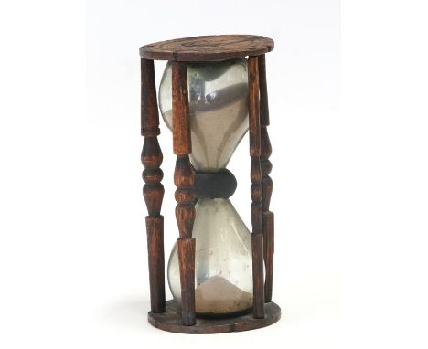 An hourglass sand timer in a treen frame, 20cms (8ins) high.