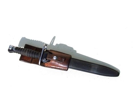 A Swiss SIG 57 bayonet in its scabbard with leather frog. Blade length 23.5cms (9.25ins)