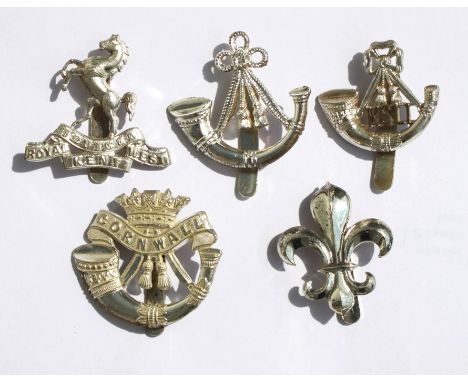 Five Military cap badges: The Duke of Cornwalls Light Infantry, The Oxfordshire &amp; Buckinghamshire Light Infantry, The Man