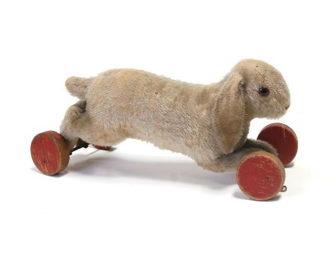 A Steiff plush pull-along rabbit, 40cms (16ins) long; together with similar plush toys.