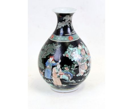 A Chinese famille noir vase decorated with figures in a landscape, six character mark to the underside and paper label dated 