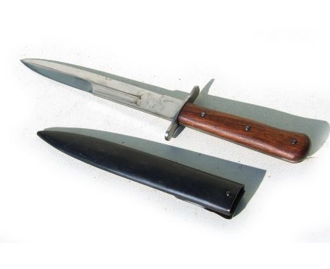 A WW2 double edged fighting knife in its metal scabbard. Blade length 17.5cms (6.875ins)