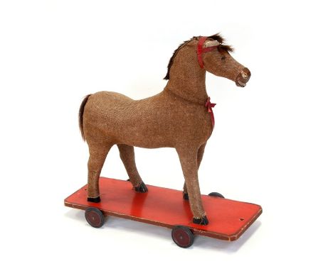 A vintage pull-along horse, 63cms (25ins) wide.